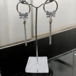 Silver hoop earrings with bow pendant